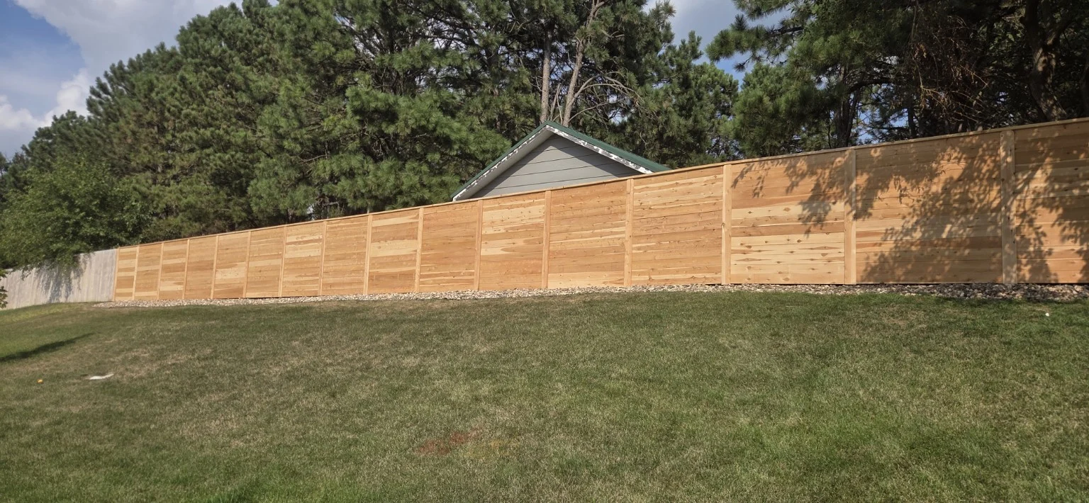 Front view of a horizontal cedar fence with driven posts in Sioux Falls