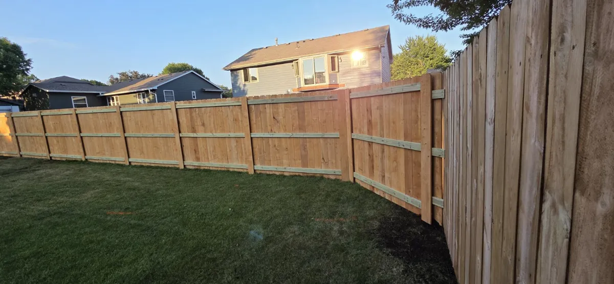 Wood privacy fence surrounding a backyard